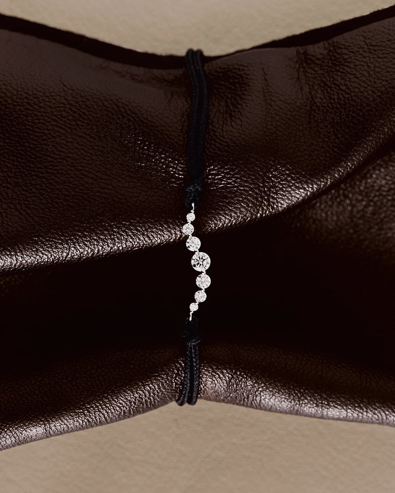 Adjustable diamond cord bracelet with a row of lab-grown diamonds in graduating sizes